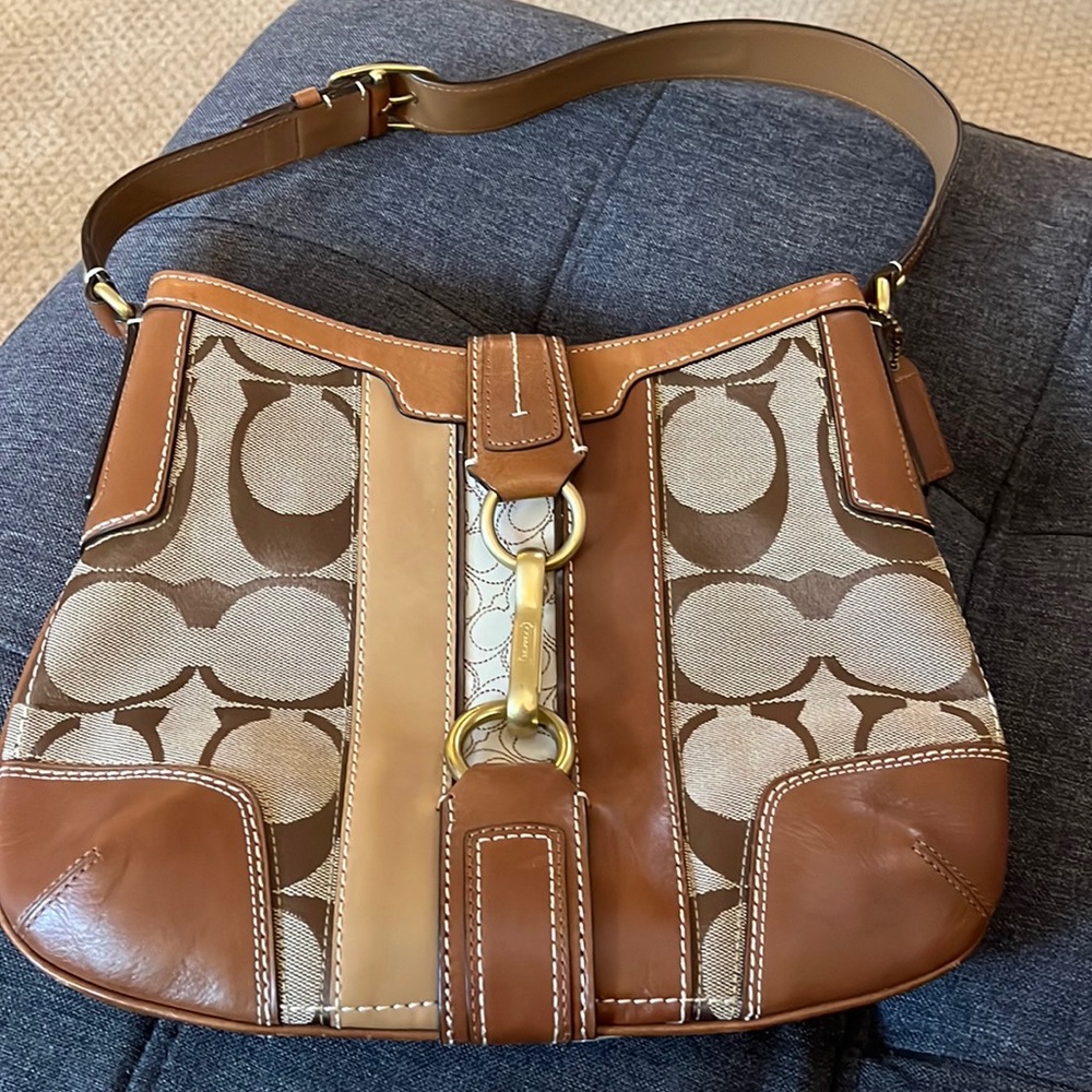 Coach handbag with gold clasp.